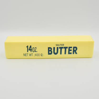 Gelber Squeeze-Riegel in Butter-Form mit der Aufschrift „14oz Salted Butter“, Frontalansicht