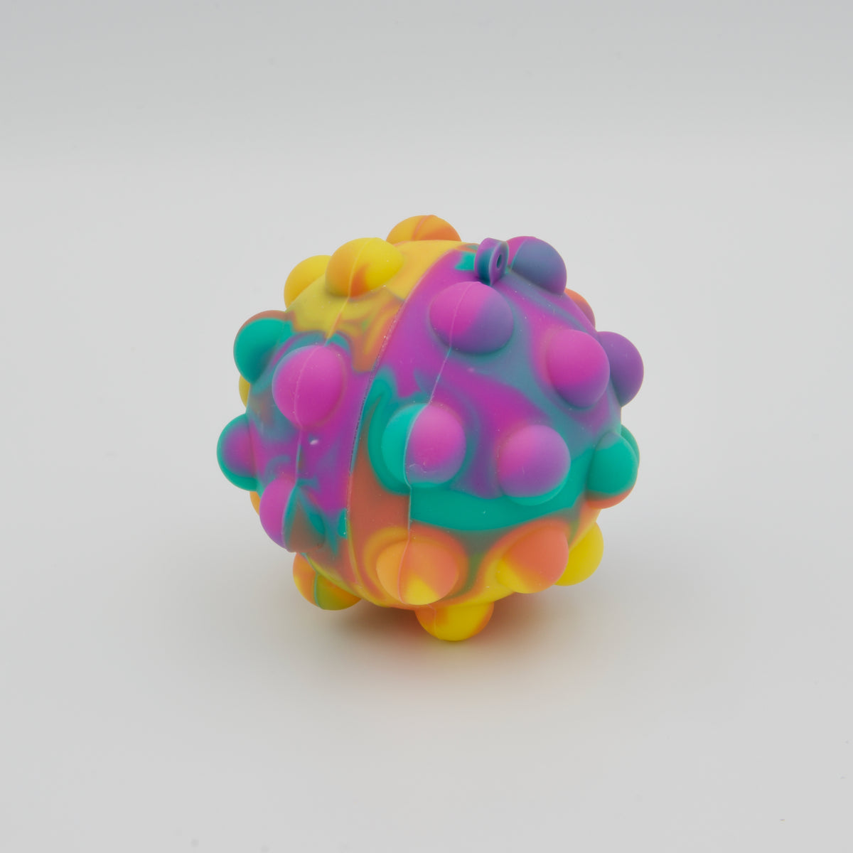 Runder Fidget-Ball aus Silikon mit Pop-Bläschen im bunten Farbverlauf aus Violett, Türkis, Gelb und Orange