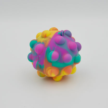 Runder Fidget-Ball aus Silikon mit Pop-Bläschen im bunten Farbverlauf aus Violett, Türkis, Gelb und Orange
