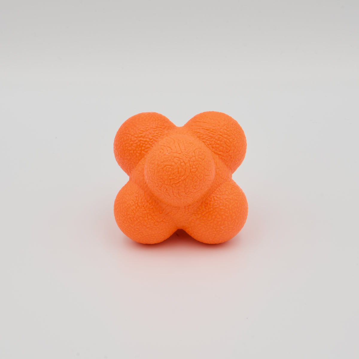 Einzelner orangefarbener Reaktionsball mit unregelmäßigen Höckern und haptischer Oberflächenstruktur.