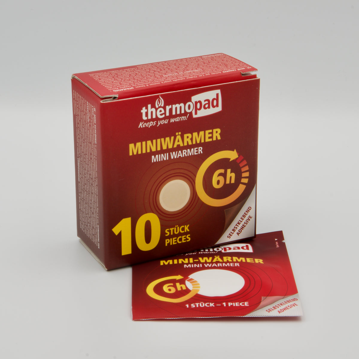 Rote Packung Thermopad Miniwärmer mit 10 selbstklebenden Wärmepads und einem ausgelegten Einzelpad